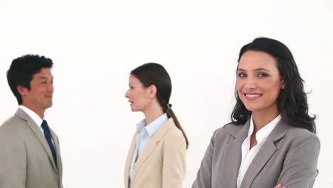 Businesswoman-posing-with-her-colleagues-talking-