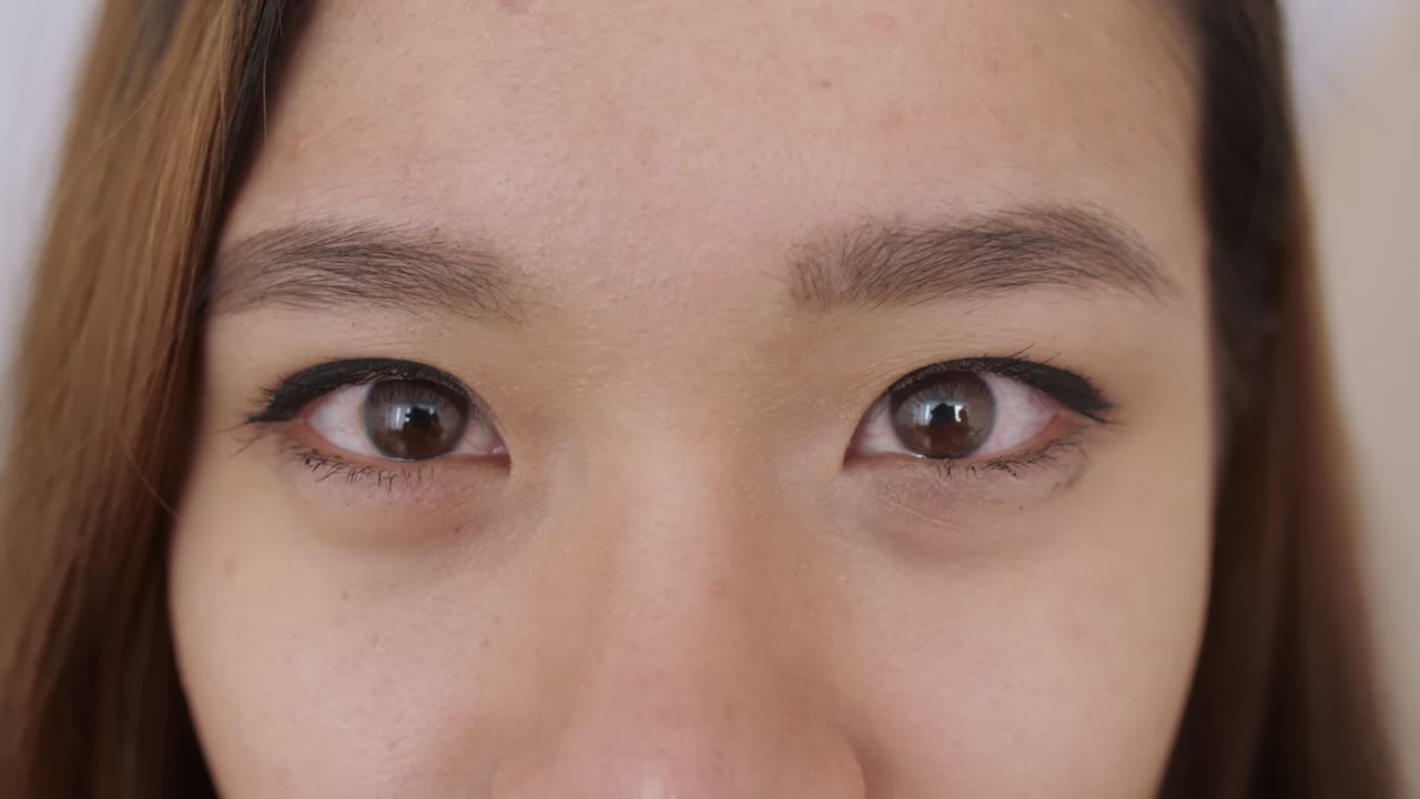 Close up of Middle Eastern young Woman Face, The girl has beautiful brown eyes, she smiles, frowns, draws her eyebrows