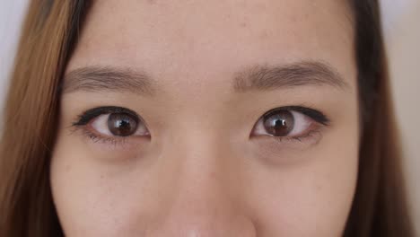 Close up of Middle Eastern young Woman Face, The girl has beautiful brown eyes, she smiles, frowns, draws her eyebrows