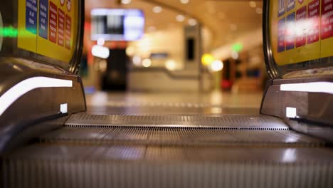 a smooth escalator ride in a brightly lit airport duty-free area, showcasing vibrant signage and a bustling environment