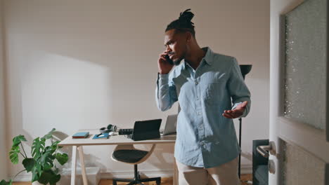 emotional man speaking mobile home office. nervous guy calling arguing cellphone