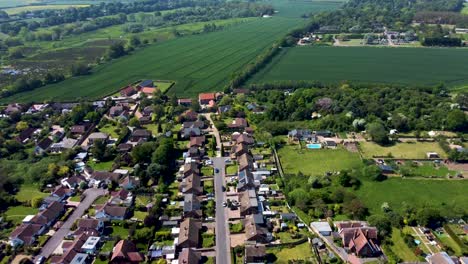 high altitude view of a road running through the village of littlebourne in kent, uk