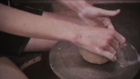 young woman makes a jug of clay. female hands mold pottery. vintage effect.