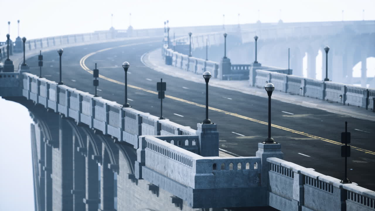 Elevated bridge road with lampposts under a hazy sky at dawn