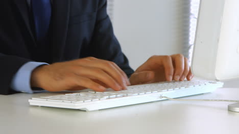 businessman typing on his computer