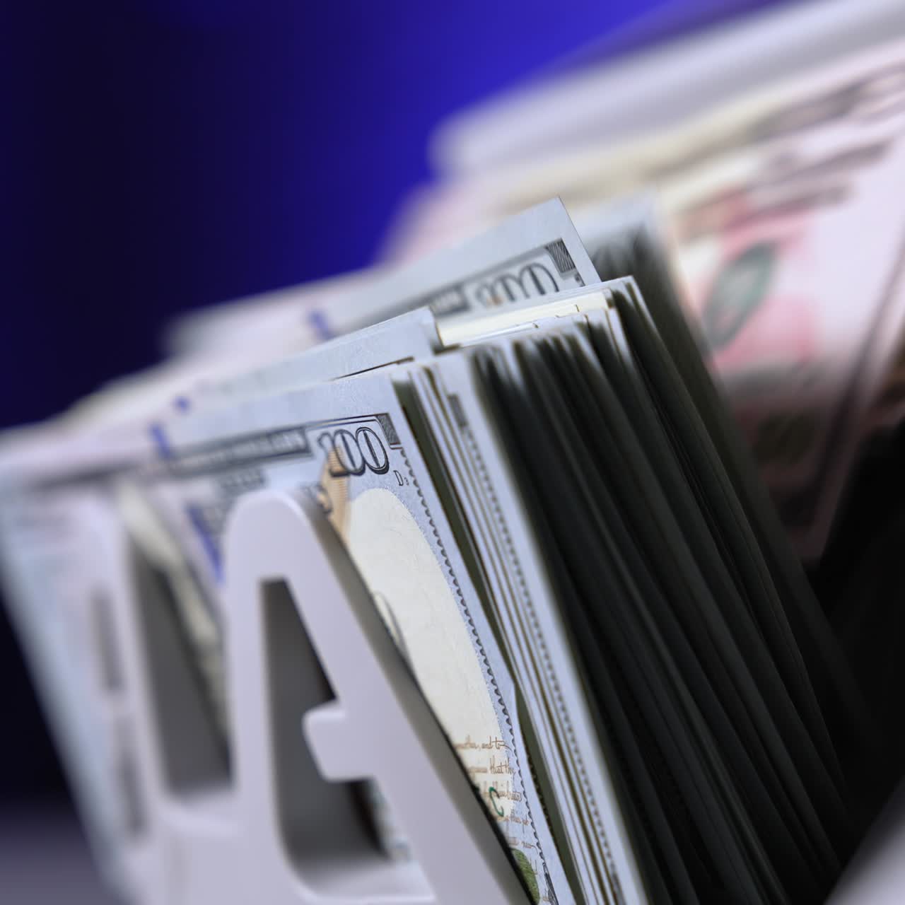 Currency counting machine counts 100 dollar bills. Cash bill counter money machine. Automatic mechanism for bank financial operations. Finance concept. Close-up