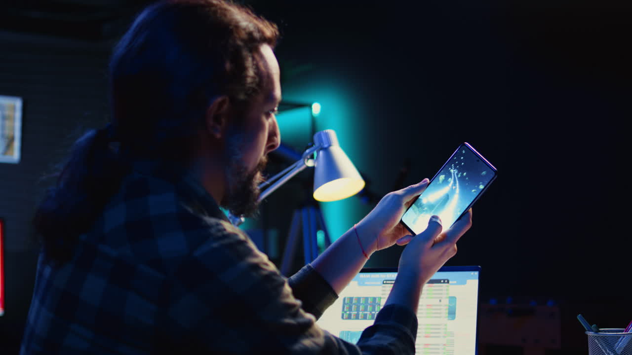 Man playing videogames on cellphone, relaxing in living room