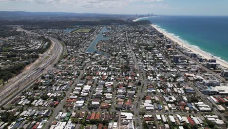 aerial view of coastal suburb of palm beach on sunny day in city of gold coast, qld, australia.