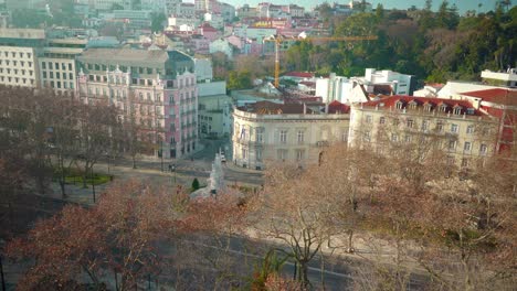 Lisbon-city-rooftop-at-morning-under-blue-sky-over-the-trees-with-empty-streets-4K