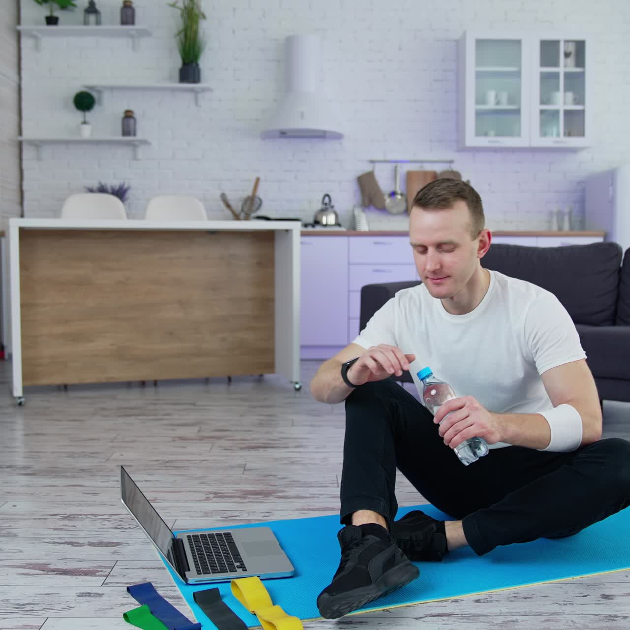 Indoor training on quarantine. Handsome athletic man doing exercise in home