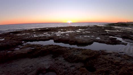 time-lapse of the sun setting over the tide pools left at low tide, puerto peñasco, gulf of california, mexico