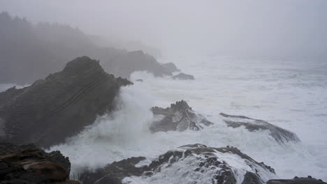 ocean waves breaking against rocky coast of shore acres state park in coos bay, oregon on a stormy day