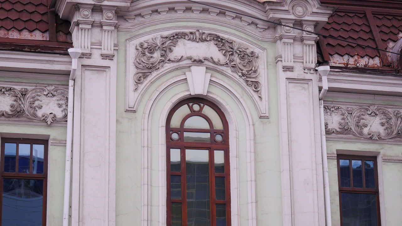 Ornate Facade of an Old Building with Detailed Windows