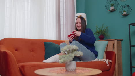 mujer adicta divertida y preocupada jugando con entusiasmo a videojuegos de carreras en el teléfono móvil en casa