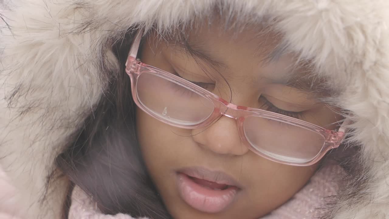 Girl in winter coat and glasses