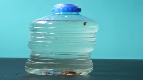 a plastic water bottle with a blue cap and clear water inside