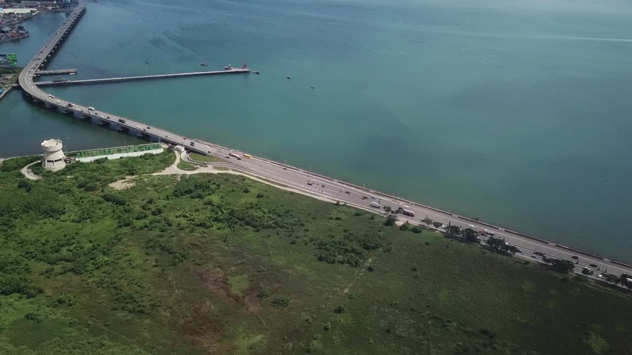 Cebu South Coastal Road, Philippines. Drone Aerial View of Seaside Traffic and SRP Tower Landmark