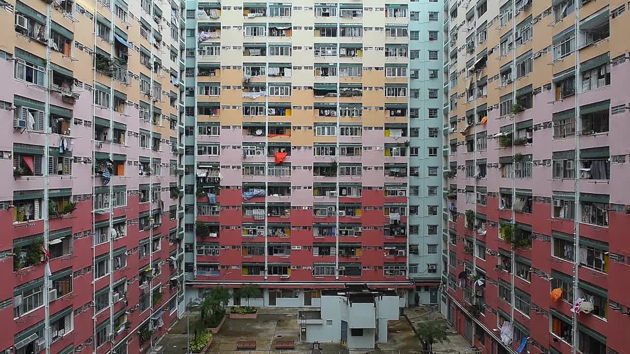 Facade of dense apartment buildings in Kowloon, Hong Kong, showcasing the high-rise architecture, urban density, and vertical cityscape that define one of the most populated areas in the world