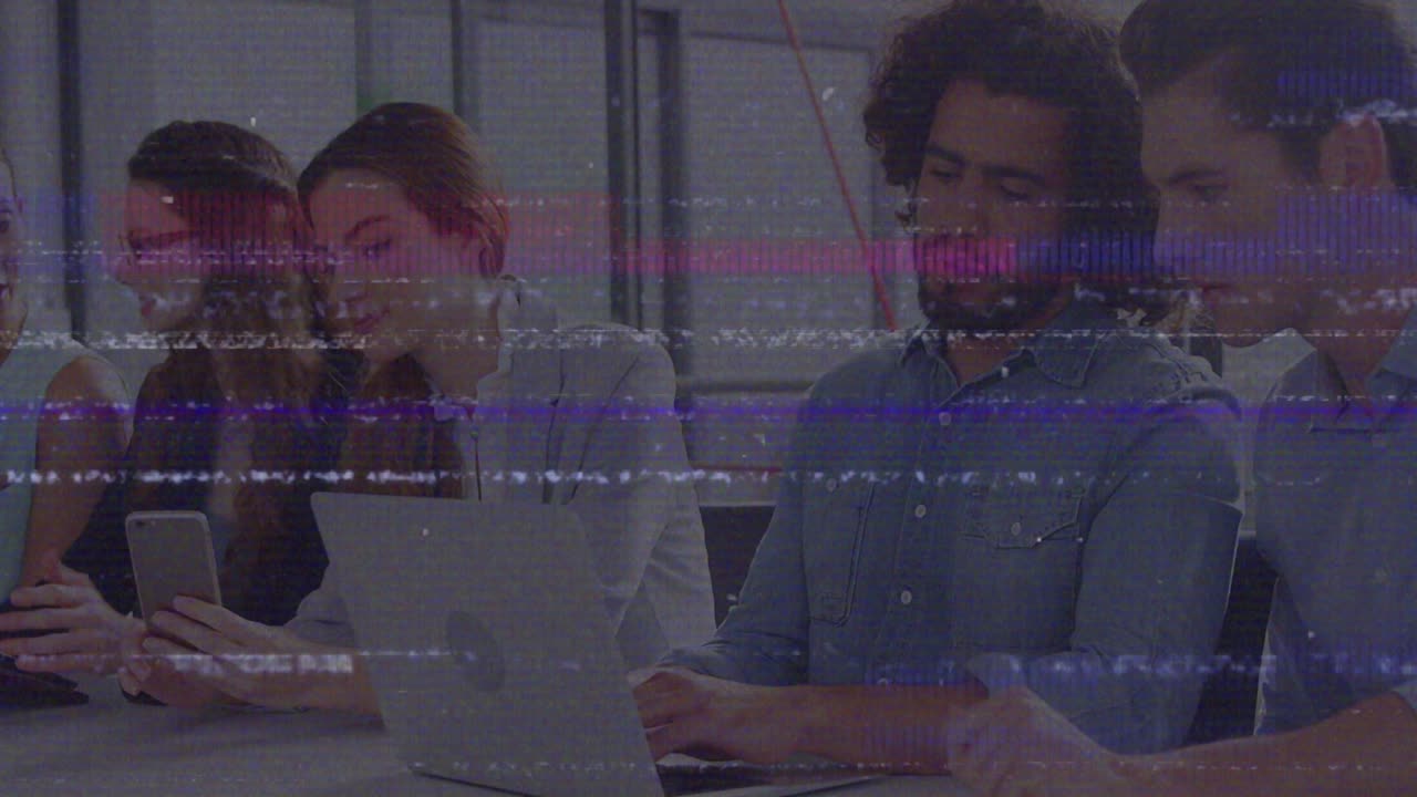 Animation of screen with glitch over diverse female and male coworkers in office