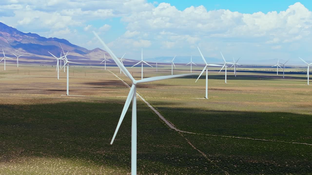 Wind turbines on Nevada plains harness energy under blue sky