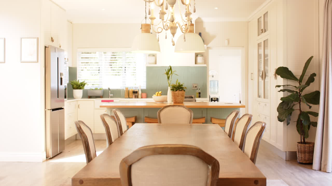 Modern kitchen and dining area with wooden table and elegant chairs
