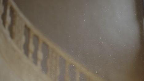 Particles-over-a-beautiful-stone-stairs-and-light-coming-from-a-window-inside-an-old-castle