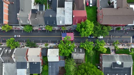 ascending above a small american town during the 4th july celebrations