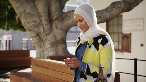 young woman wearing hijab out and about in the city