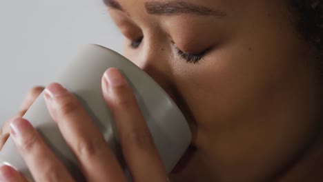 woman having a coffee in living room