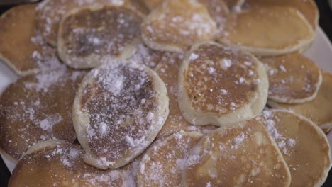 freshly baked american pancakes sprinkled with powdered sugar