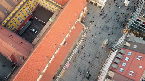 top down view aerial shot capturing the architectural marvel of munich's frauenkirche, surrounded by the vibrant red rooftops of the city