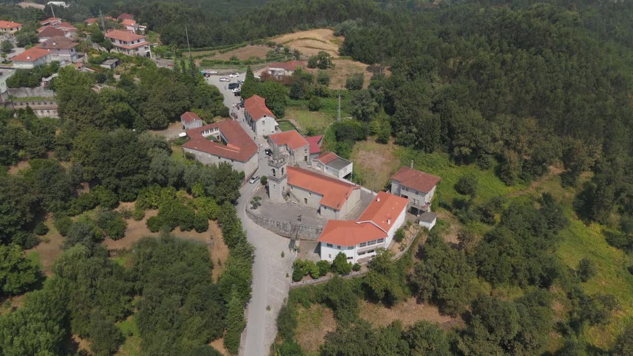 High drone view of the Sobradelo da Goma church complex surrounded by dense Minho countryside in the municipality of Póvoa de Lanhoso Portugal