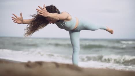 weighing balance core yoga pose at barcelona spain beach