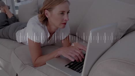 animation of data processing over caucasian woman using laptop