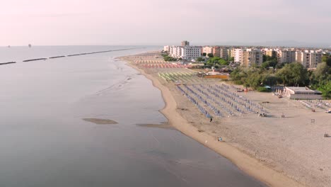 aerial view of sandy beach with umbrellas and gazebos