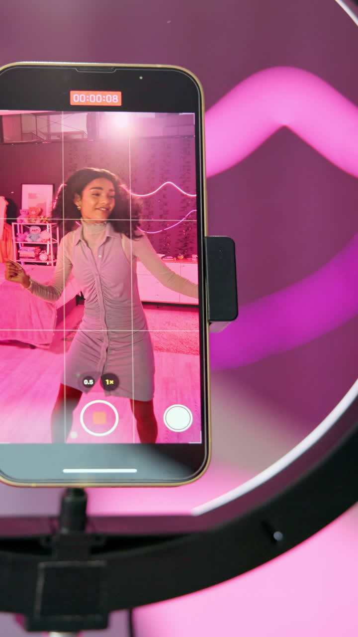 Woman recording video with cell phone