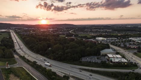 beautiful colorful sunset over lancaster county, pennsylvania, usa highway, aerial drone timelapse, hyperlapse of traffic moving