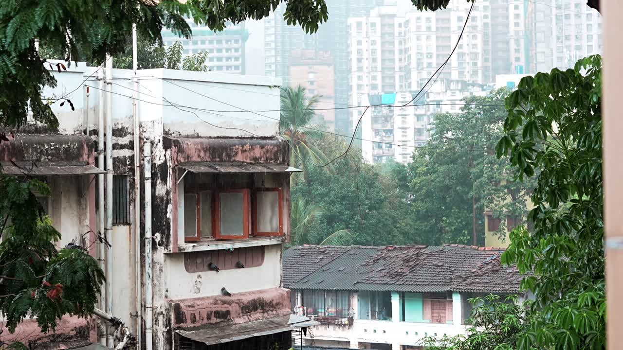 Rains in Mumbai,Mumbai City in the rain balcony view from window trees in foreground
