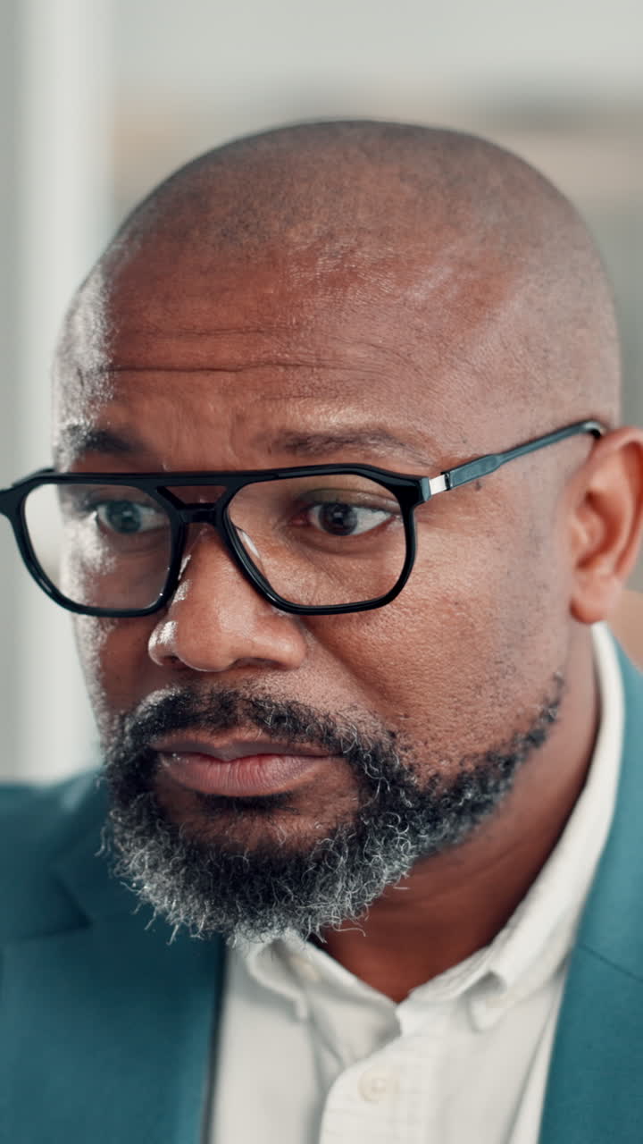 Close Up of a Focused Black Businessman Putting on Glasses