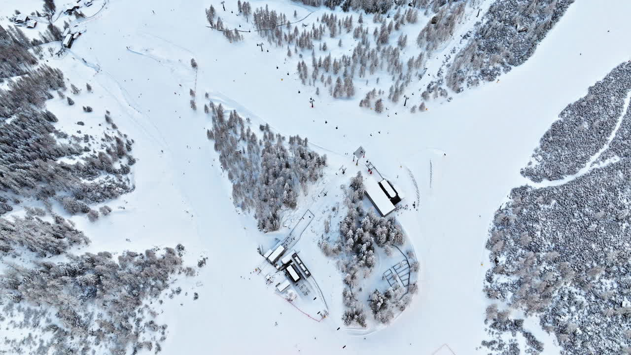 Aerial drone view of the Colfosco mountain village covered in snow, in South Tyrol, Dolomites, Northern Italy