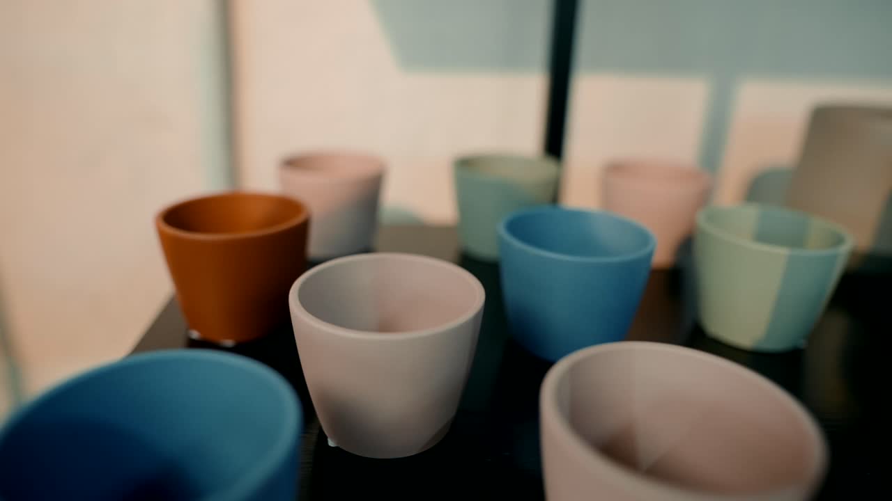 A collection of colorful ceramic mugs