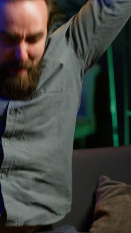 vertical video angry man looking at sports broadcast raging, releasing pent up emotions