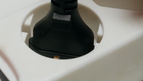 close-up of a power plug inserting into an electrical outlet