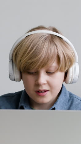 boy listening to music on a laptop