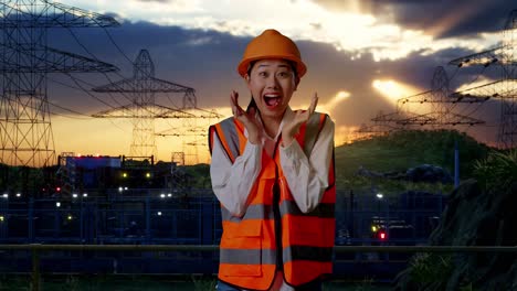 surprised female engineer at power plant sunset