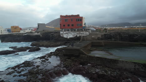 Toma-Aérea-En-órbita-Sobre-Una-Mujer-Y-Donde-Se-Puede-Ver-La-Costa-De-La-Playa-De-Boca-Barranco-Y-Durante-La-Puesta-De-Sol