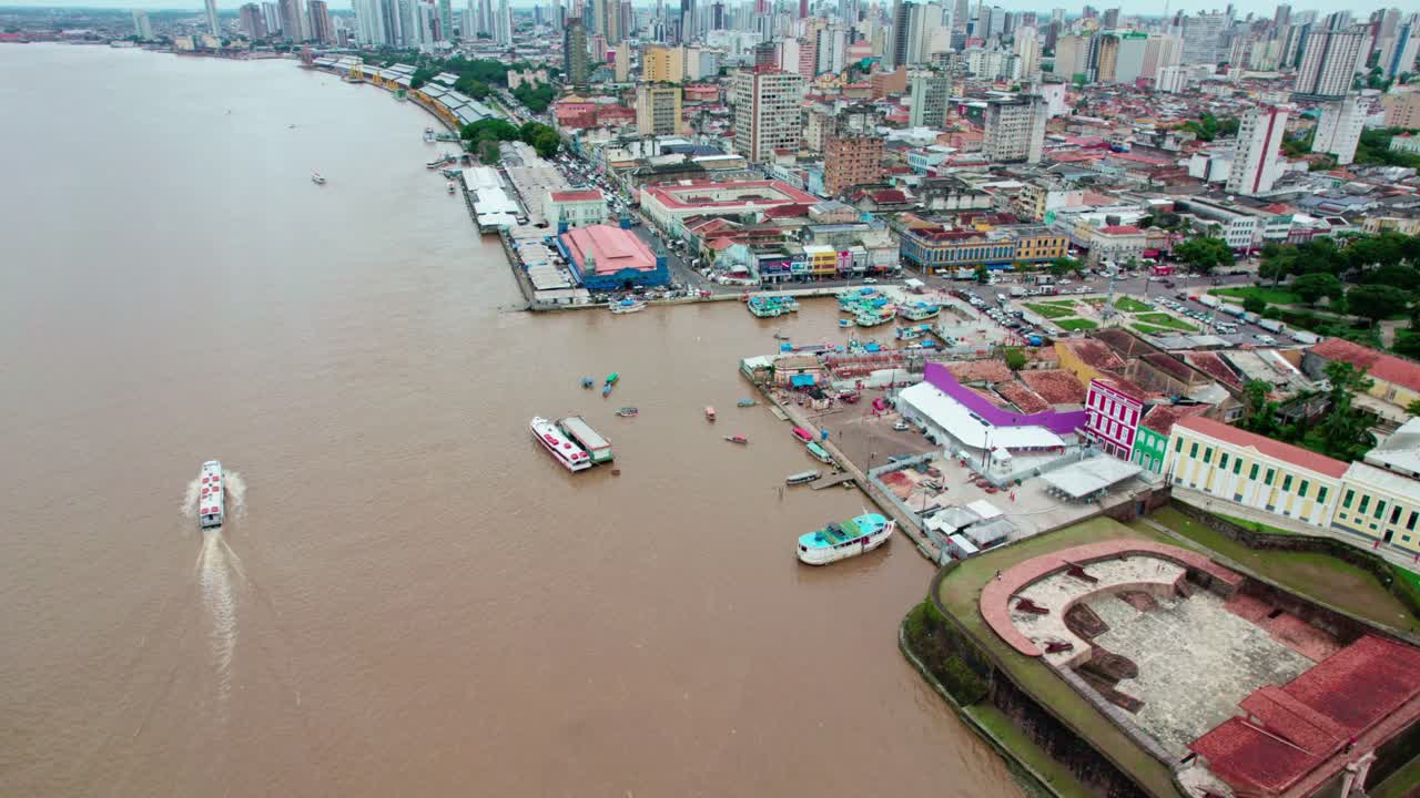 Boats and buildings line bustling waterfront of Belém, Brazil, aerial