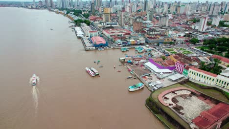 boats and buildings line bustling waterfront of belém, brazil, aerial