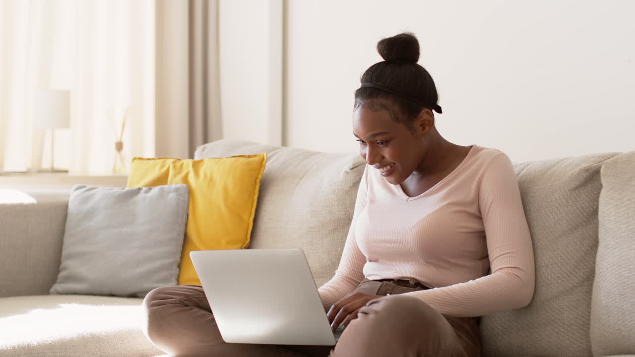 Young Woman Working on Laptop at Home