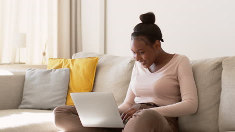 young woman working on laptop at home